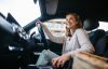 Happy Woman Driving Her New Electric Car.